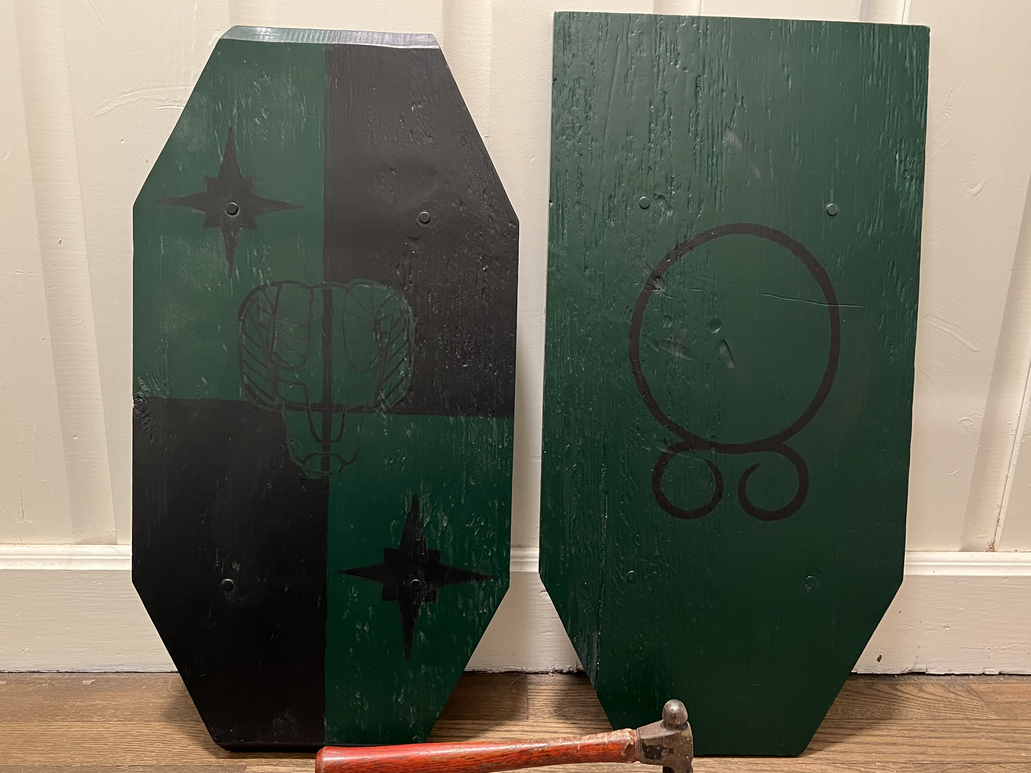 Two Green Shields with Black Designs