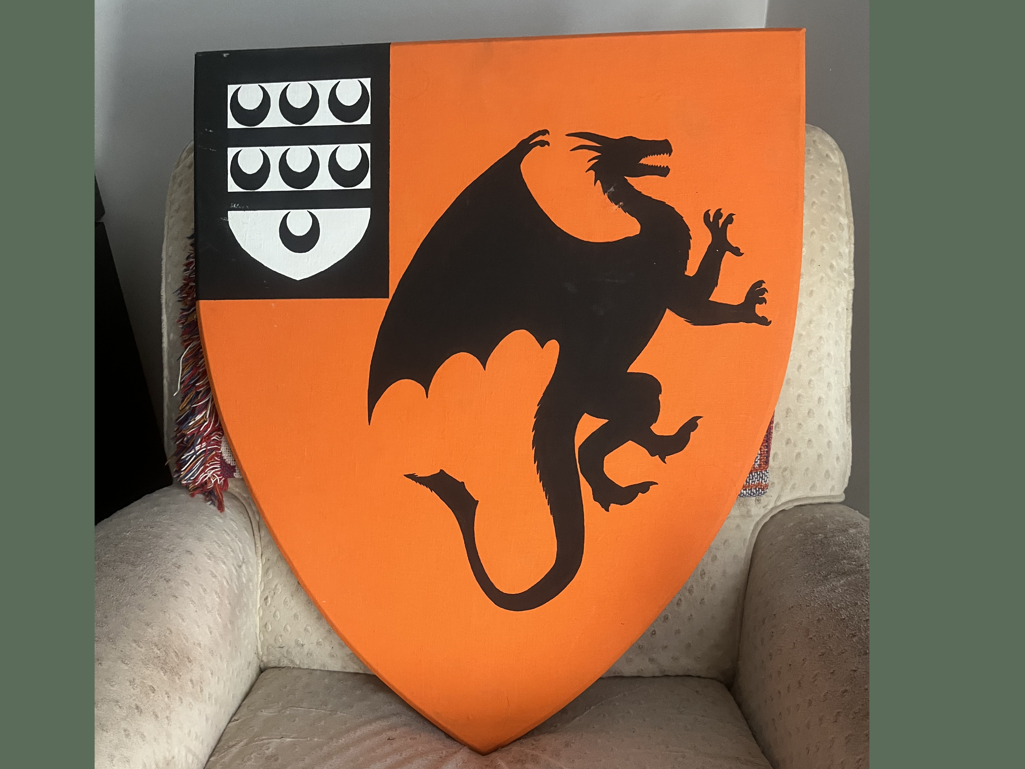 Orange Shield with Black Dragon Design